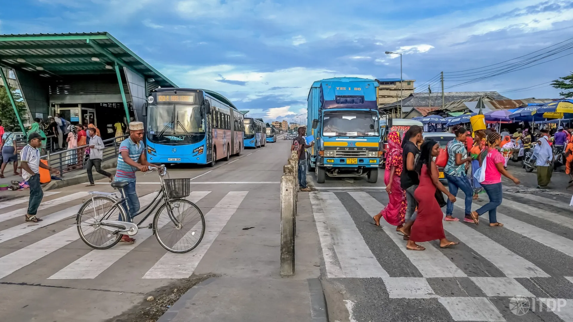 A scene of a zebra crossing on Morogoro Road in Dar Es Salaam, Tanzania – a featured image of Transforming Transportation 2024. Photo: Clayton Lane for ITDP Africa/Flickr
