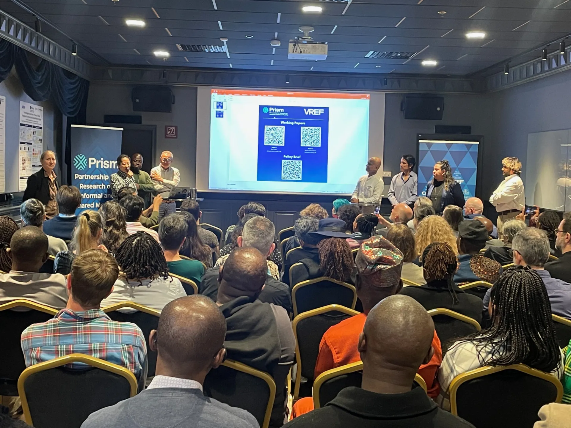 Participants engage with outputs from PRISM research sessions, highlighting key themes of governance, climate resilience, and electrification pathways.